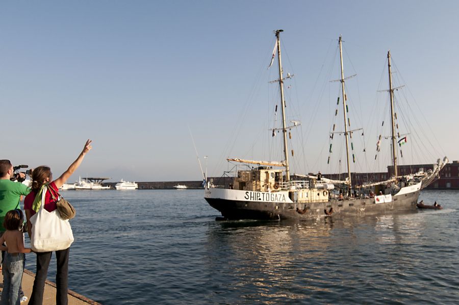 Populares acompanham a partida do navio Estelle, no porto de Nápoles, neste sábado, dia 6. / Maddalena Tartaro/AFP